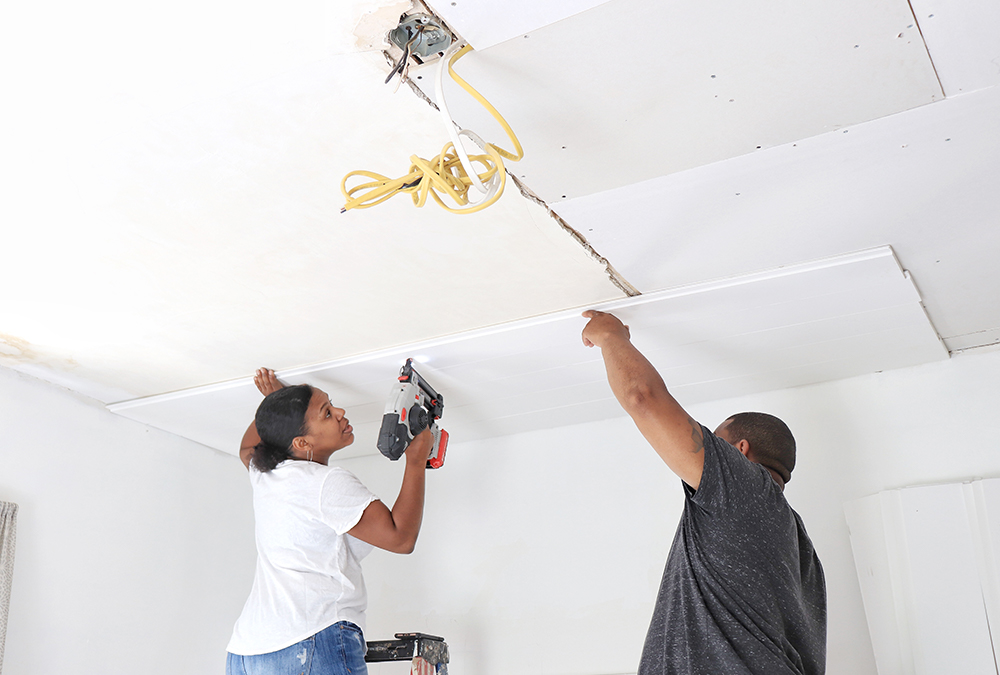 couple prepping a ceiling for shiplap